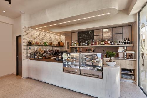 a restaurant with a counter in a room at Stay 365 Heraklion Apart Hotel in Heraklio Town