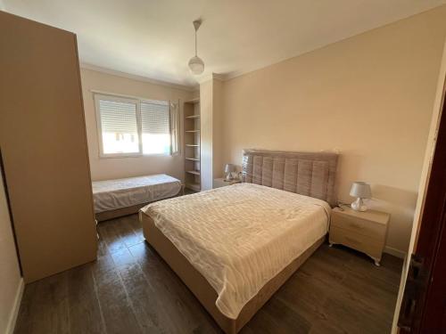 a bedroom with two beds and a window at ABX seaview Apartment in Golem