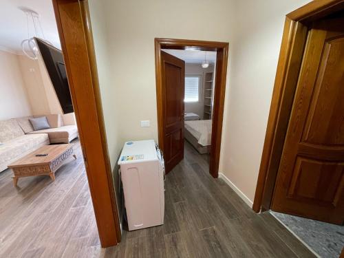 a living room with a refrigerator in the middle of a room at ABX seaview Apartment in Golem