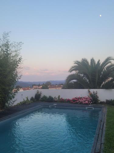a swimming pool with a view of a body of water at Alijó Douro House in Alijó