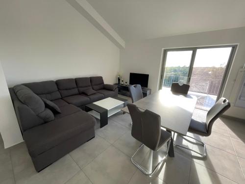 a living room with a couch and a table at Apartments Lia-Jolie in Umag