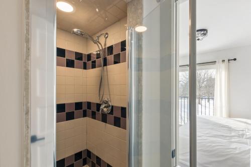 a bathroom with a shower with black and white tiles at Collingwood Chalet Near Blue Mountain Slopes 39B in Collingwood