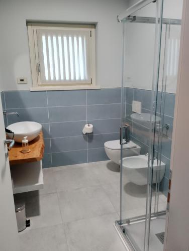 a bathroom with a toilet and a glass shower at B&B LA VALLUNA in Erbusco