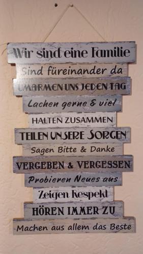 a sign hanging on a wall with writing on it at Gasthaus zur blauen Donau in Wesenufer