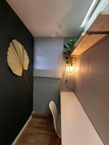a room with a white bench and an umbrella on the wall at Hostel new way in Sao Paulo