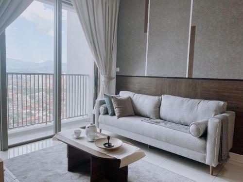 a living room with a couch and a table at Skydeck with KL City View Cozy 2 Bedroom in KL in Kuala Lumpur