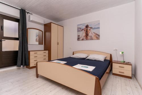a bedroom with a bed and a mirror at Sea view apartment Dominique in Cavtat