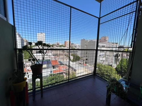 a room with a large window with a view of a city at Malabia in Buenos Aires