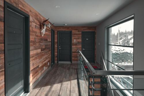 a room with two doors and a balcony at L'étoile du lac lyster in Coaticook