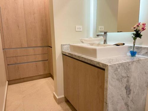 a bathroom with a sink and a shower at 2BR Modern 5th Avenue Apt -Distrito Corazon D1 in Playa del Carmen