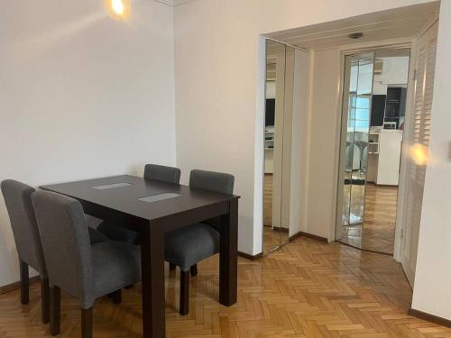 mesa de comedor con sillas y espejo en Departamento 2 AMB con amenities en Buenos Aires