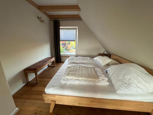 a large bed in a room with a window at Ferienhaus "Haus am See" in Prenzlau