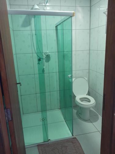 a bathroom with a glass shower with a toilet at Casa do Vo Lelo in Penha