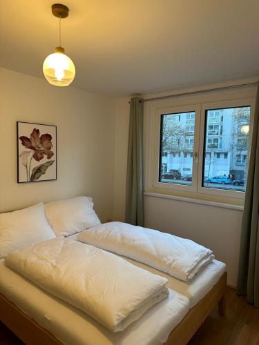 two beds in a room with two windows at Amazing City Center Apartment in Vienna