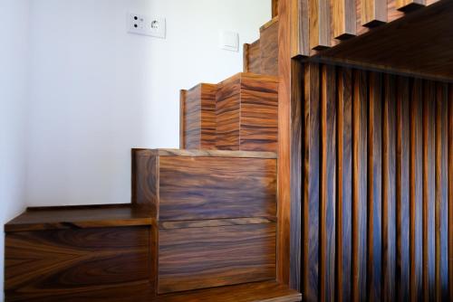 a wooden stair case with wooden panels on it at Casa do Ferreiro in Macedo de Cavaleiros