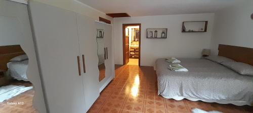a small bedroom with a bed and a hallway at Baita salzkabe in Macugnaga