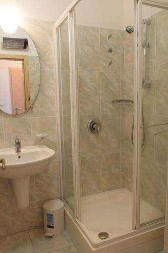 a bathroom with a shower and a sink at apartmány Marco Shipping in České Budějovice