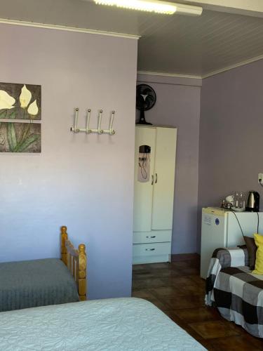 Ένα ή περισσότερα κρεβάτια σε δωμάτιο στο Pousada Simone