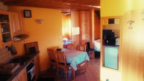 a kitchen and dining room with a table and chairs at Apartment Beli Zajec in Mozirje