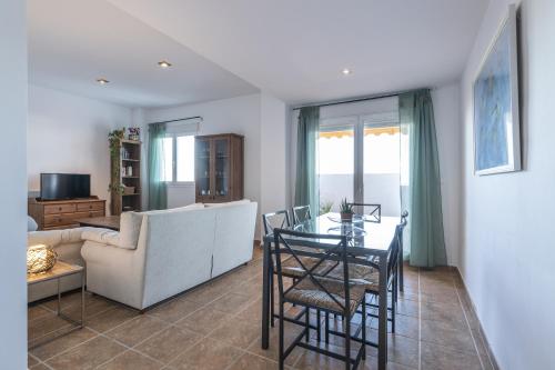 a living room with a couch and a table at ÁTICO ATALAYA Parking privado gratis in Ayamonte