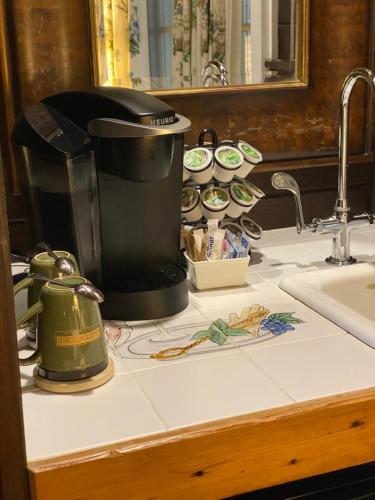 a kitchen counter with a coffee maker and a sink at Goodstone Inn & Restaurant in Middleburg