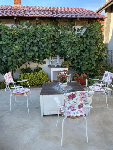a group of chairs and a table on a patio at Bela Vila in Negotin