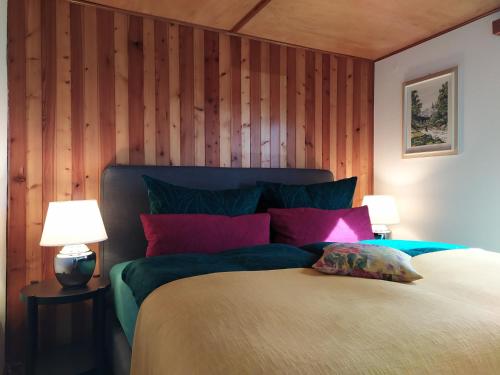 a bedroom with a large bed with wooden walls at Försterhaus am Linowsee in Rheinsberg