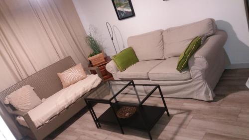 a living room with a couch and a coffee table at Japan Beach Parque del Oeste in Málaga
