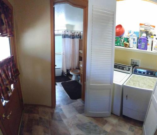 a small kitchen with a sink and a washer at Cabin on the Corner in Big Bear Lake