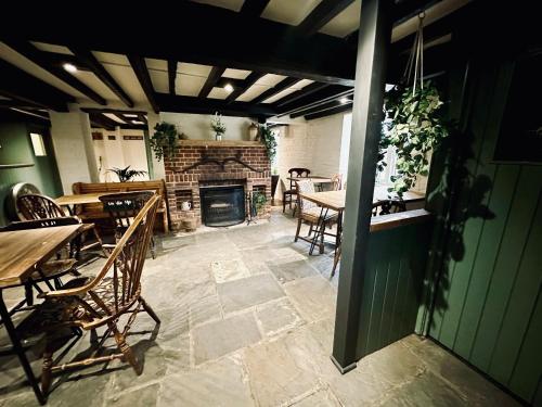 a patio with tables and chairs and a fireplace at The Old Mill in Salisbury