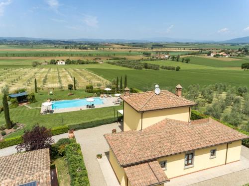 an aerial view of a villa with a swimming pool in a field at Corte Delle Stelle in Cortona