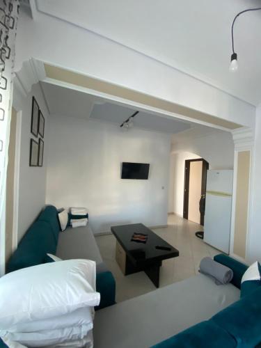 a living room with a couch and a table at Elti Apartment in Sarandë