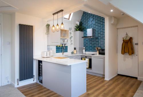 a kitchen with white cabinets and a counter top at Moor View Apartment, near city centre and stadium in Town Moor