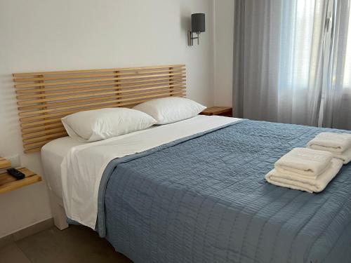 a bedroom with a bed with two towels on it at Villa Calliope in Himare
