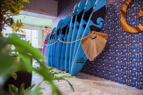 a row of blue surfboards lined up against a wall at Seven Beach TLV - By 7even Hotels in Tel Aviv