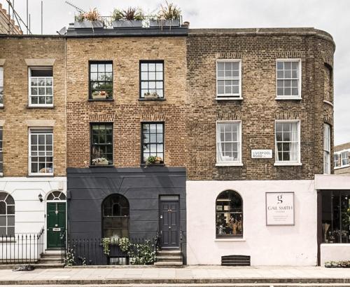 un edificio de ladrillo con puertas y ventanas negras en Stunning Townhouse with large roof terrace en Londres