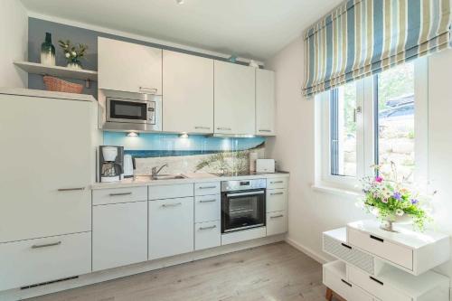 Dapur atau dapur kecil di APPARTEMENT TRAUMSTERN 21 - zum Strand wenige Geh Minuten