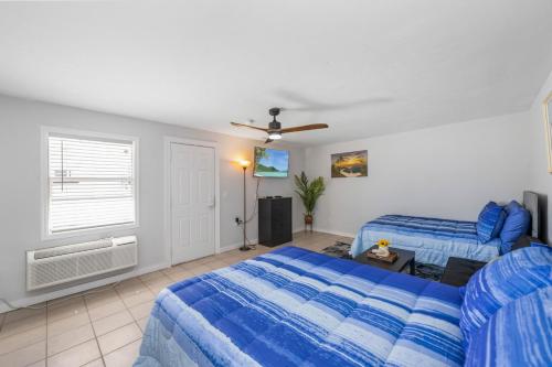 um quarto com 2 camas e uma ventoinha de tecto em 2 Bed Cottage with Pool, Close to Beach! BBQ Grills & Patio em Fort Myers
