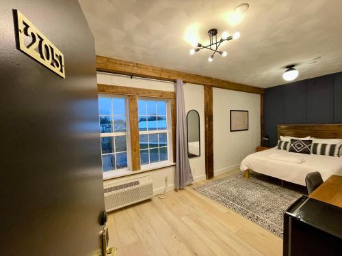 a bedroom with a bed and a window at 205 - Queen Suite in Waunakee