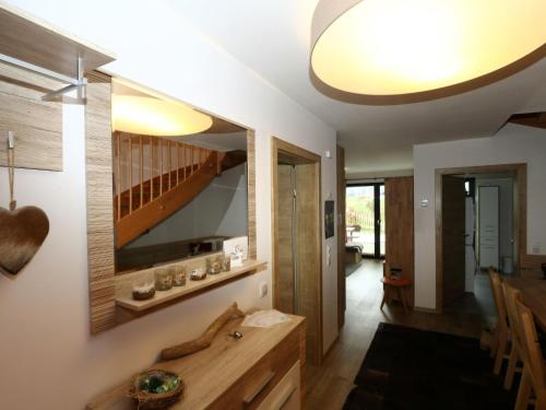 a living room with a wooden table and a staircase at Chalet Alpenzauber mit beheiztem Pool, Inzell in Inzell