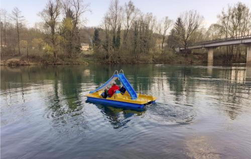 a person in a small boat on a river at Awesome Home In Ozalj With Kitchen in Ozalj