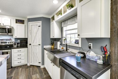 a kitchen with white cabinets and a counter top at Charming Perry Home about 2 Mi to the Gulf! in Perry