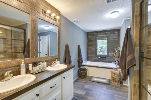 a bathroom with two sinks and a bath tub at Charming Perry Home about 2 Mi to the Gulf! in Perry