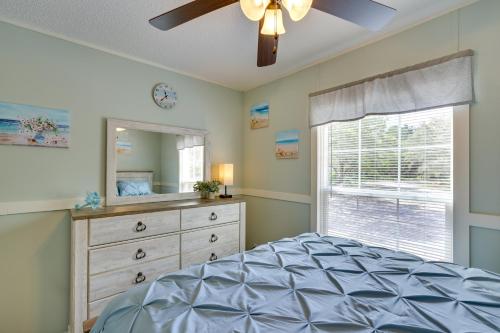 a bedroom with a bed and a dresser and a window at Charming Perry Home about 2 Mi to the Gulf! in Perry