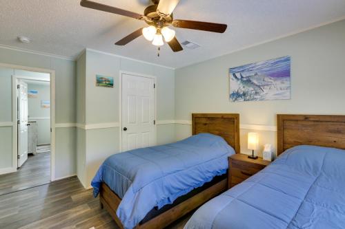a bedroom with two beds and a ceiling fan at Charming Perry Home about 2 Mi to the Gulf! in Perry