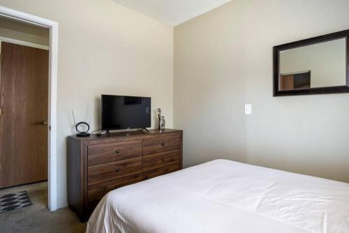 a bedroom with a bed and a television on a dresser at Comfortable and Bright 3-Bedroom Home in Tucson in Tucson