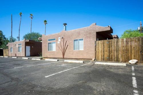 a house in a parking lot with a fence at Comfortable and Bright 3-Bedroom Home in Tucson in Tucson