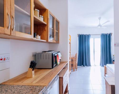 a kitchen with a counter top with a microwave at B8-03 Studio, Apt 22, Mwangani Apartments in Fumba