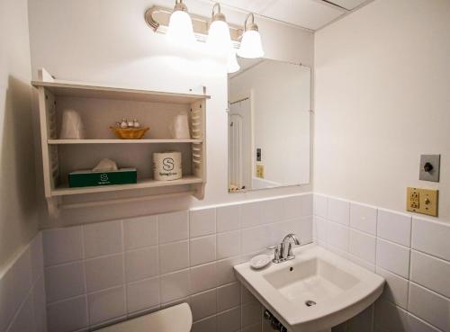 a bathroom with a sink and a mirror at Courtyard Resort in Hyannis