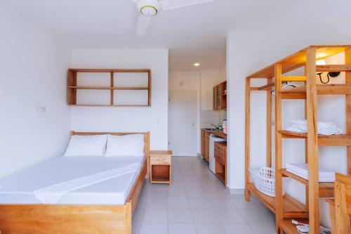 a room with a bed and bunk beds in it at B8 Studio, Apt 22, Mwangani Apartments in Fumba